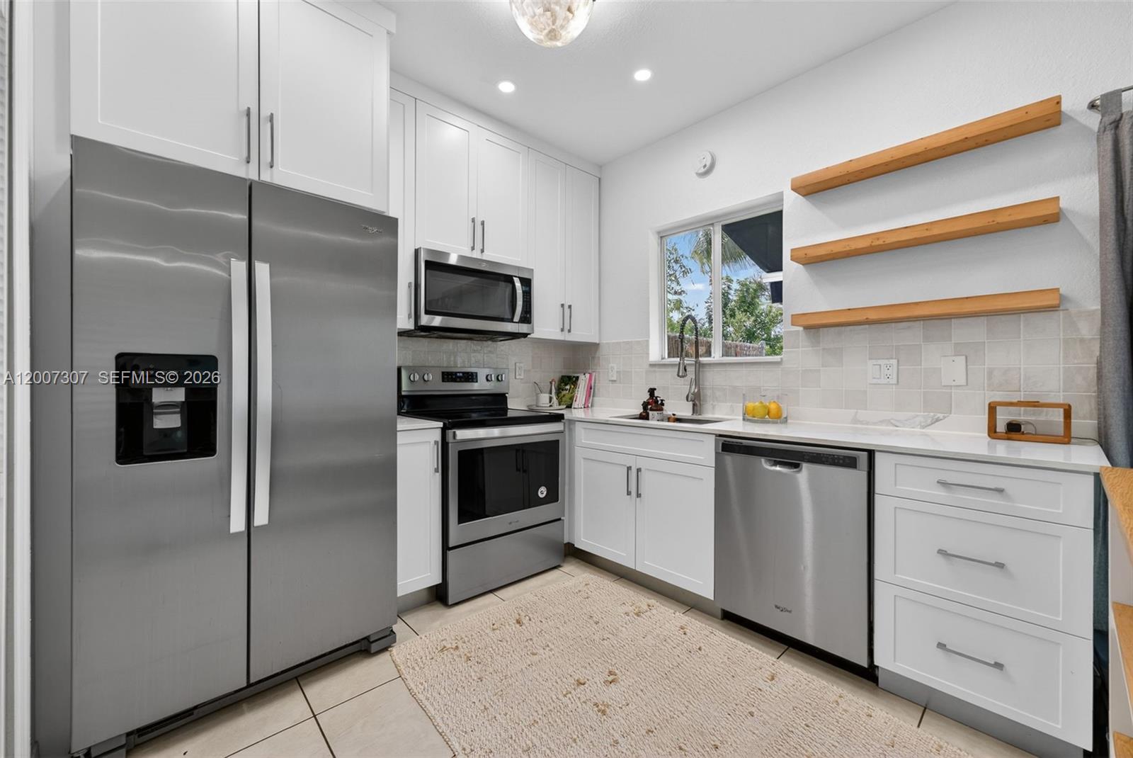12310 Southwest 216th Street Miami, FL 33170 - Photo 8 of 22 a kitchen with cabinets stainless steel appliances and a window