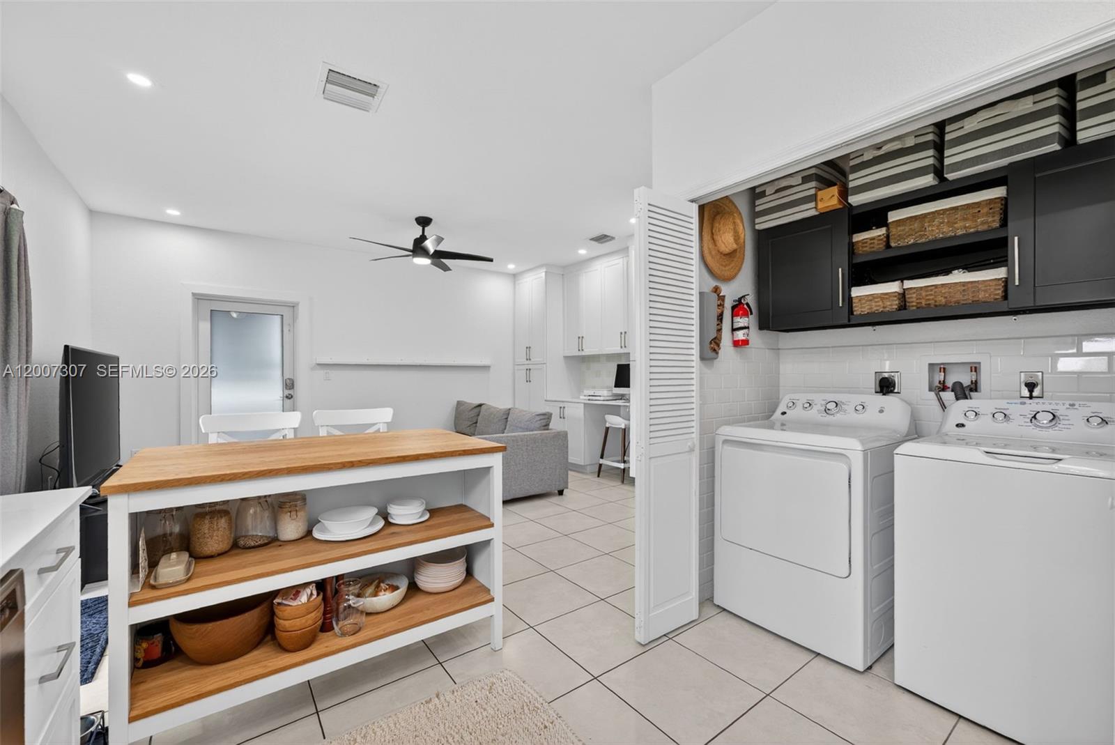 12310 Southwest 216th Street Miami, FL 33170 - Photo 9 of 22 a view of washer and dryer with kitchen in the background