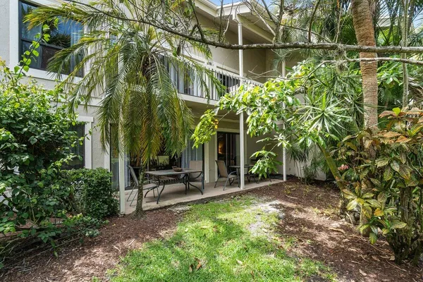 an aerial view of a house with a swimming pool outdoor seating and yard