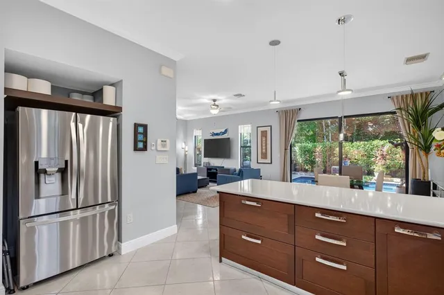 a kitchen with stainless steel appliances granite countertop a refrigerator and a sink