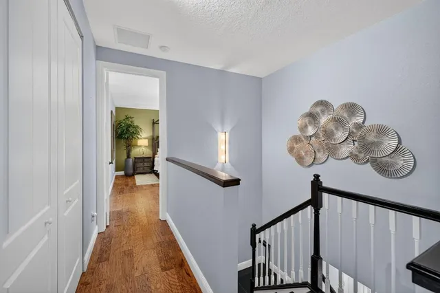 a bedroom with a bed a chandelier and a large window