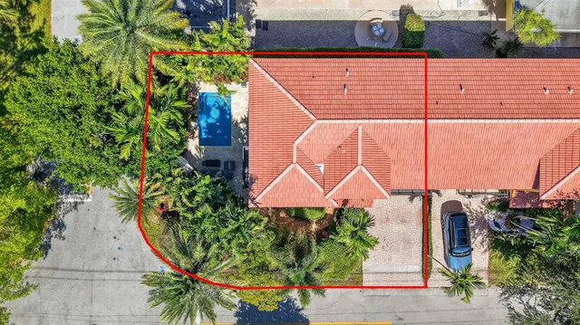 an aerial view of residential houses with street