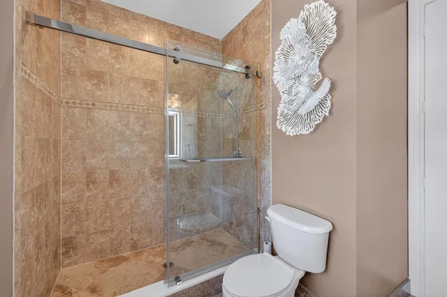 a bathroom with a toilet a sink and mirror