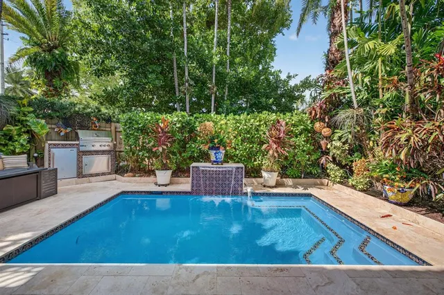 a swimming pool with outdoor seating and yard