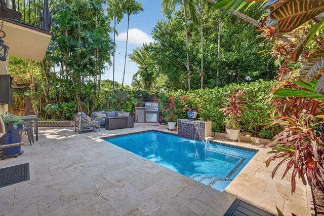 a view of a swimming pool with an outdoor seating