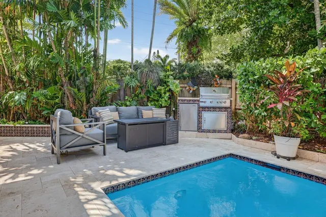 a view of a backyard with furniture and a garden