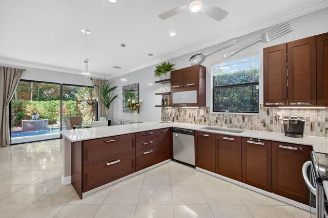 a large kitchen with kitchen island granite countertop a sink window and cabinets