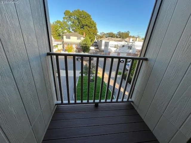 a view of a balcony with wooden floor