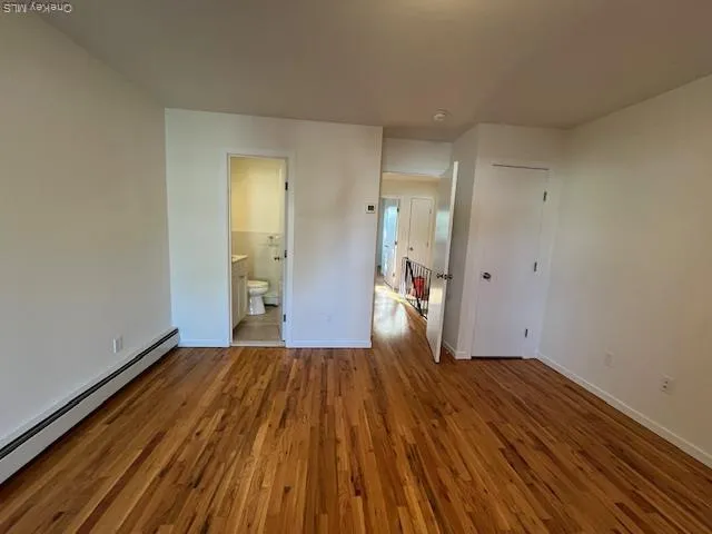 a view of a room with wooden floor