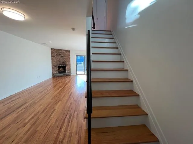 a view of entryway and hall with wooden floor