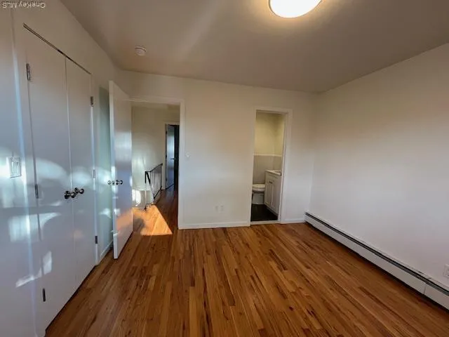 a view of a room with wooden floor