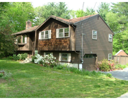 128 Allen Road Billerica, MA 01821 - Photo 1 of 16 a front view of a house with a garden