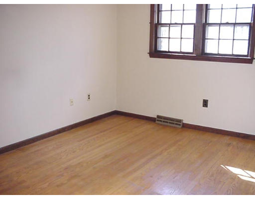 128 Allen Road Billerica, MA 01821 - Photo 13 of 16 an empty room with wooden floor and windows
