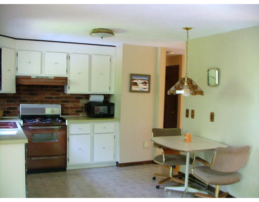 128 Allen Road Billerica, MA 01821 - Photo 6 of 16 a kitchen with a table and chairs in it
