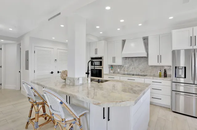 a kitchen with stainless steel appliances granite countertop a sink and cabinets