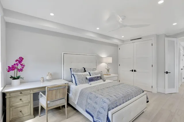 a bedroom with a large bed and a chandelier