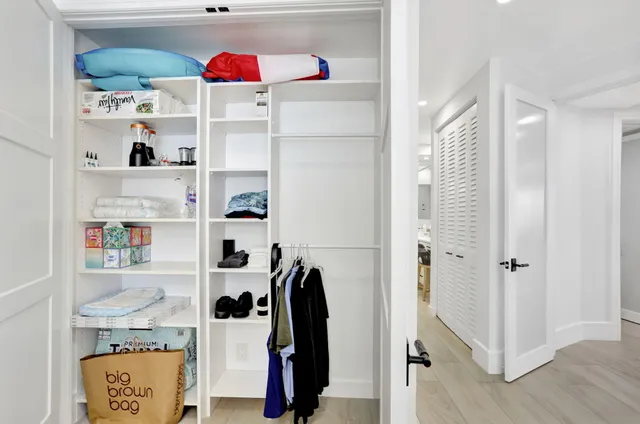 a view of a hallway with washer and dryer