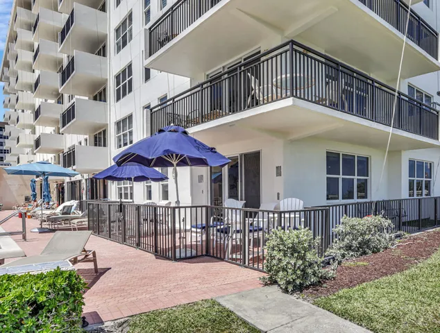 a front view of a house with yard and porch