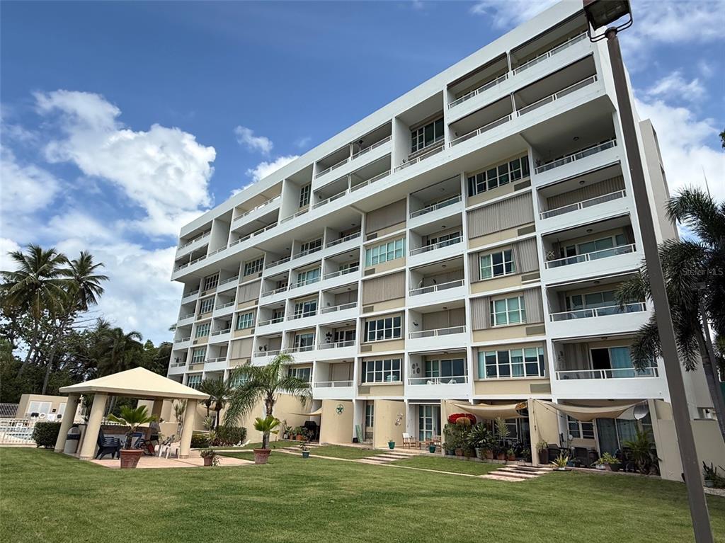 Condo Pelican Reef Condo Pelican Reef, Unit 302 Rincon, PR 00677 - Photo 15 of 16 a front view of building with yard