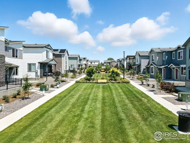 a view of yard with swimming pool and seating
