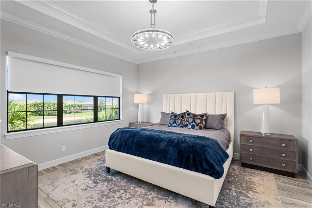 9673 Montelanico Loop, Unit 202 Naples, FL 34119 - Photo 14 of 46 a spacious bedroom with a bed and a large window