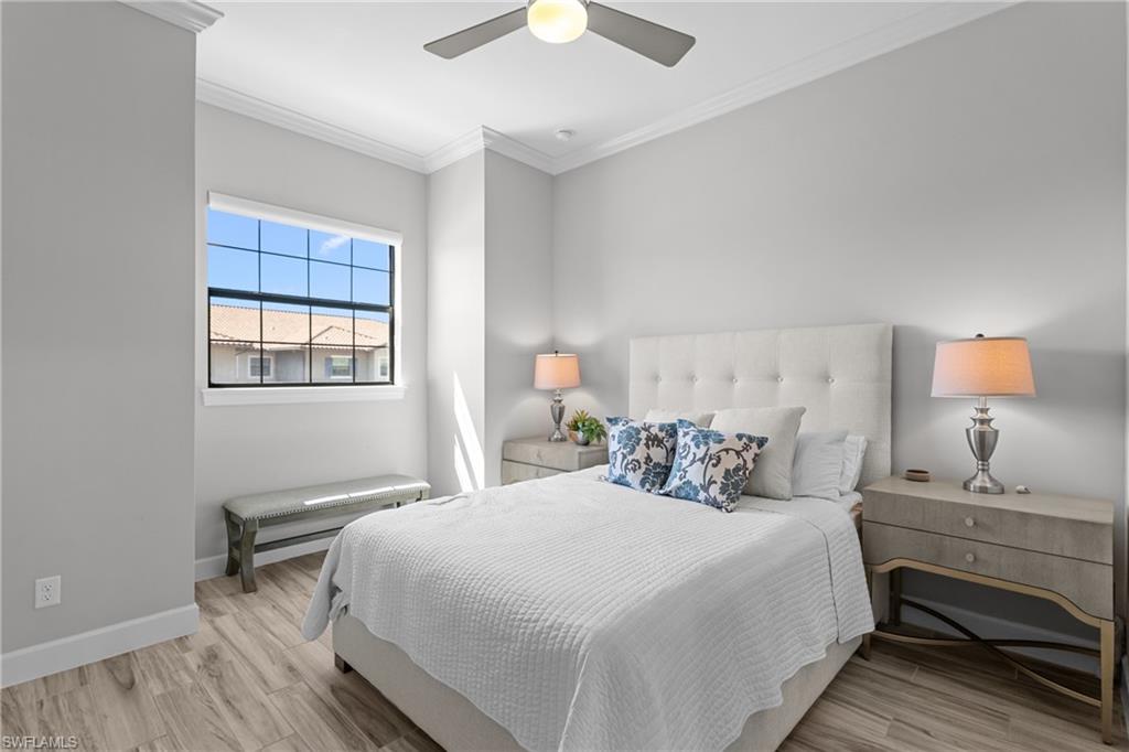 9673 Montelanico Loop, Unit 202 Naples, FL 34119 - Photo 20 of 46 a bedroom with a bed and a window