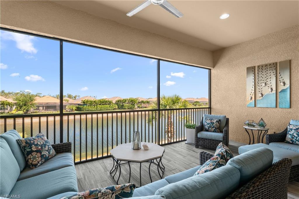 9673 Montelanico Loop, Unit 202 Naples, FL 34119 - Photo 27 of 46 a balcony with furniture and a floor to ceiling window