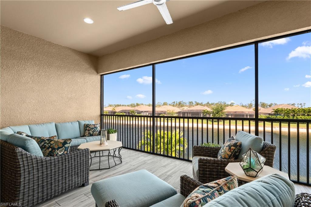 9673 Montelanico Loop, Unit 202 Naples, FL 34119 - Photo 29 of 46 a living room with furniture and a large window