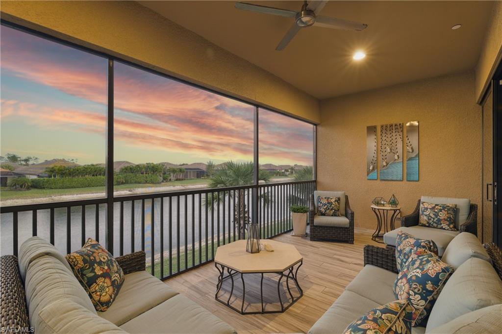 9673 Montelanico Loop, Unit 202 Naples, FL 34119 - Photo 31 of 46 a balcony with furniture and a floor to ceiling window