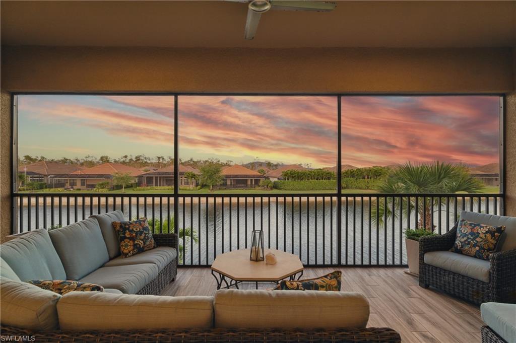9673 Montelanico Loop, Unit 202 Naples, FL 34119 - Photo 32 of 46 a balcony with couch and city view