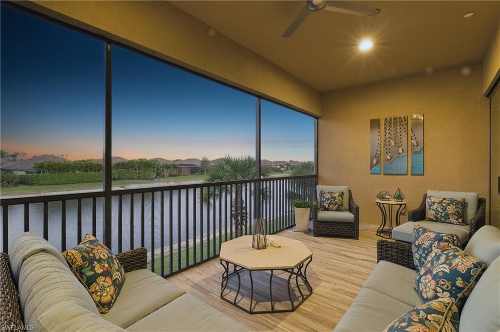 9673 Montelanico Loop, Unit 202 Naples, FL 34119 - Photo 5 of 46 a balcony with furniture and a floor to ceiling window