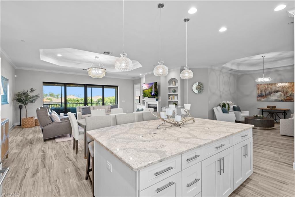 9673 Montelanico Loop, Unit 202 Naples, FL 34119 - Photo 7 of 46 a large kitchen with kitchen island a large island in it