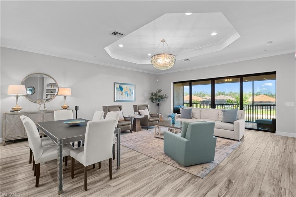 9673 Montelanico Loop, Unit 202 Naples, FL 34119 - Photo 8 of 46 a living room with furniture and a large window