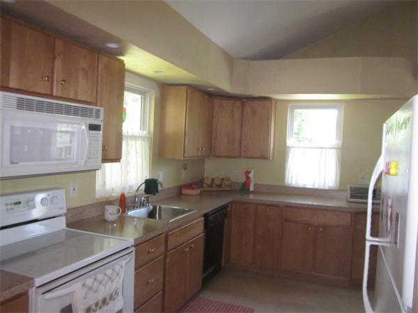10 Pillings Road Saugus, MA 01906 - Photo 2 of 13 a kitchen with a sink stove and cabinets