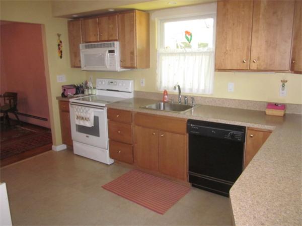 10 Pillings Road Saugus, MA 01906 - Photo 3 of 13 a kitchen with stainless steel appliances granite countertop a stove a sink and a microwave