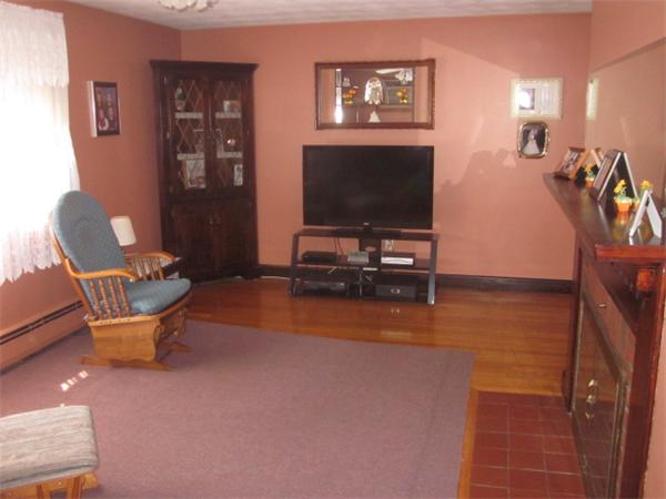 10 Pillings Road Saugus, MA 01906 - Photo 7 of 13 a living room with furniture and a flat screen tv