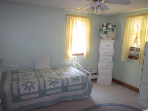 10 Pillings Road Saugus, MA 01906 - Photo 8 of 13 a bedroom with a bed next to a window and a chandelier