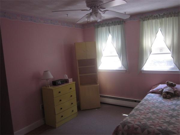 10 Pillings Road Saugus, MA 01906 - Photo 9 of 13 a bedroom with a bed and a window