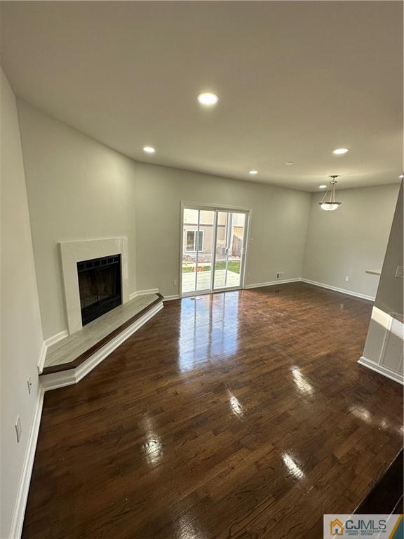 3605 Hana Road Edison, NJ 08817 - Photo 9 of 25 an empty room with wooden floor and fireplace