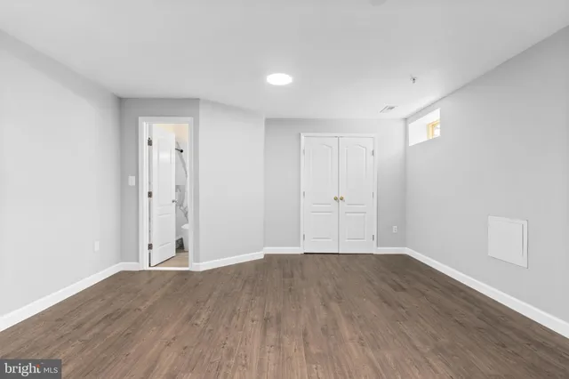 a view of wooden floor and windows in a room