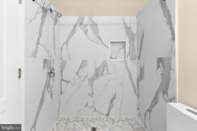 a bathroom with a bathtub sink and mirror