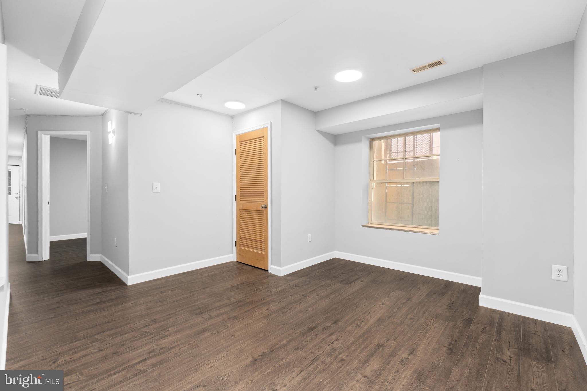 1829 Providence Street Northeast, Unit B Washington, DC 20002 - Photo 20 of 37 an empty room with wooden floor and windows