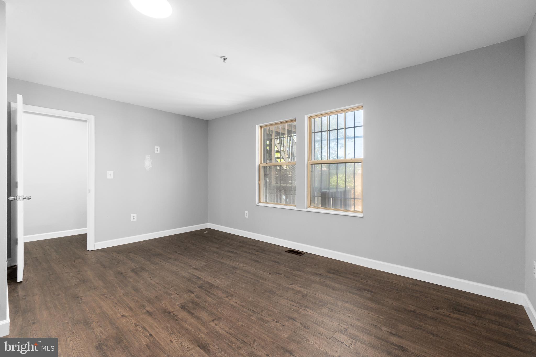 1829 Providence Street Northeast, Unit B Washington, DC 20002 - Photo 23 of 37 an empty room with wooden floor and windows