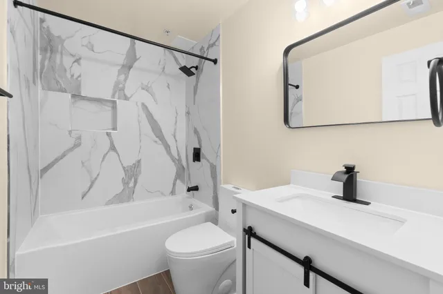 a bathroom with a sink a toilet and a bathtub