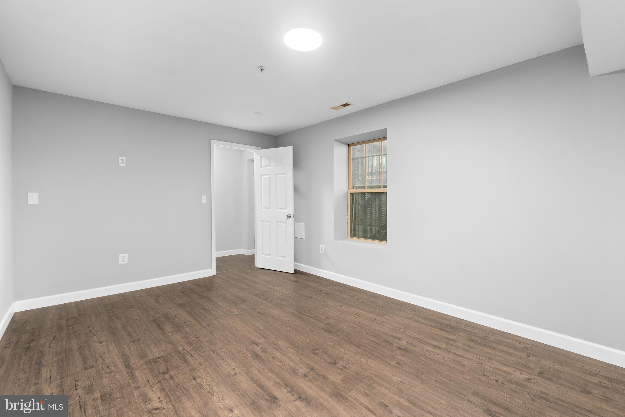 1829 Providence Street Northeast, Unit B Washington, DC 20002 - Photo 31 of 37 a view of an empty room with wooden floor and a window