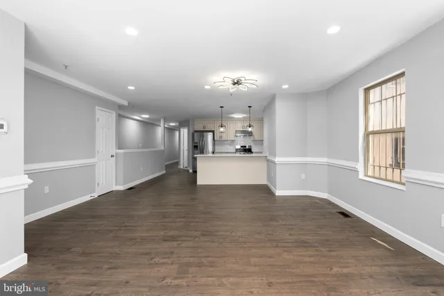a view of a kitchen with wooden floor and a kitchen
