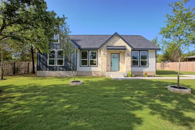 a front view of a house with a yard