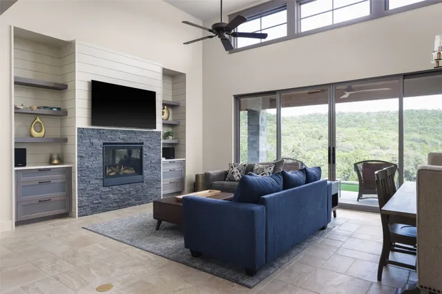 a living room with furniture a flat screen tv and a fireplace