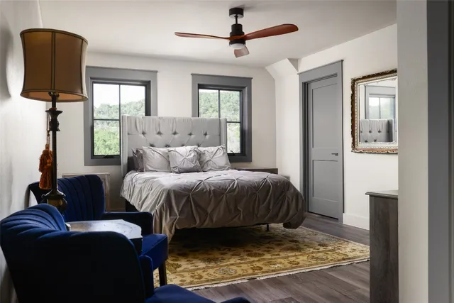 a spacious bedroom with a bed a couch and a window