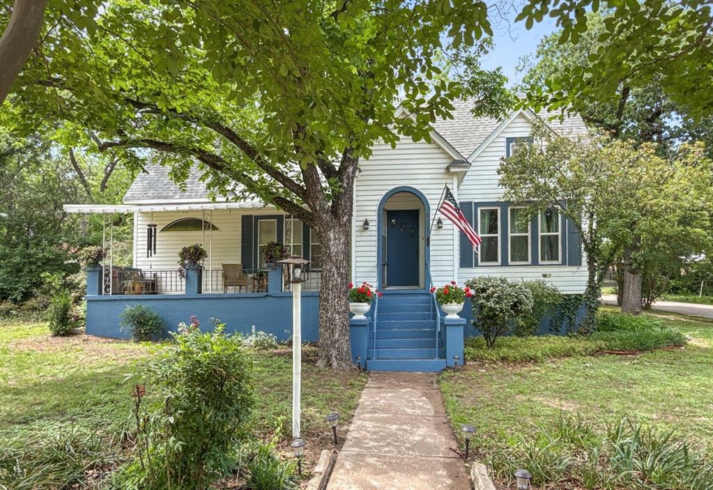 a front view of a house with garden